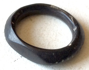 A well polished jet ring with some minor damage in a few places