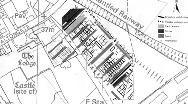 A greyscale plan orientated North with a extract from a geophysical survey overlain onto a map of Malton - this shows a very concentrated arrangement of earth ramparts, ditches, and roads - this plan also shows street names such as Old Maltongate, and buildings such as The Lodge, and includes an illustration and label marking a 'Dismantled Railway' along the North side