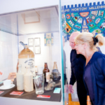 Visitors looking at museum displays in glass cases.