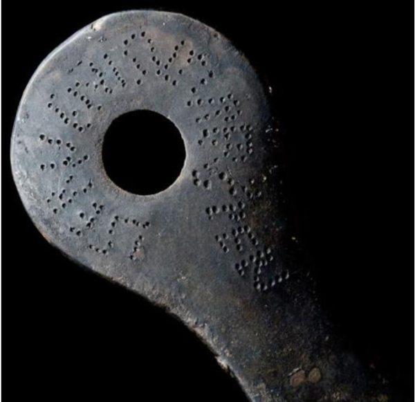 Close up of a Roman inscription punched in metal