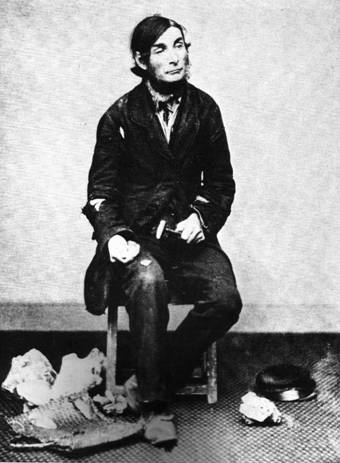 A black and white Victorian portrait of a seated man wearing a suit.