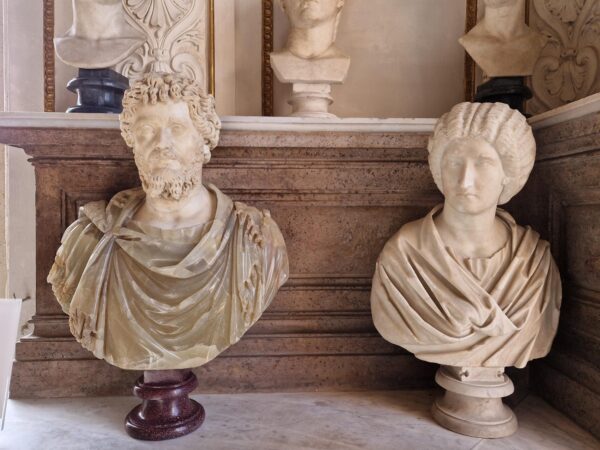 Two marble busts depicting a man and woman, in a classical styles