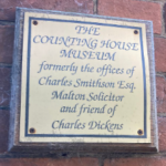A brass plaque titled 'The Counting House Museum'