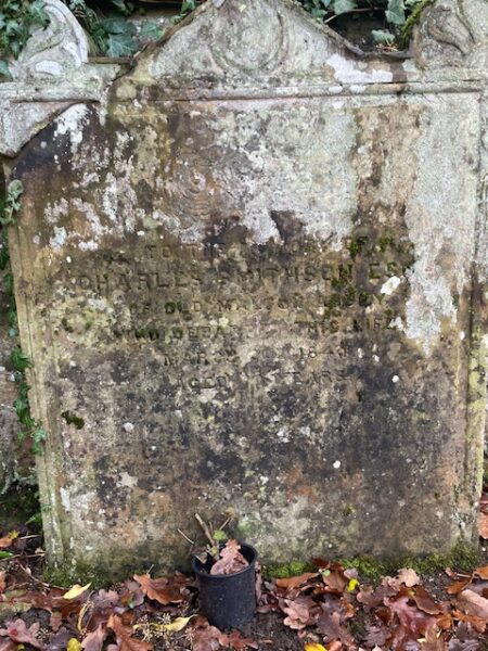A gravestone marked by lichen